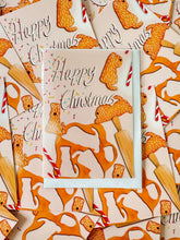 Load image into Gallery viewer, gingerbread soft coated wheaten terriers being made with a rolling pin, sweets and icing. Drawn by Harriet Billingham in a fun playful style