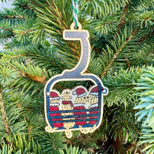 Load image into Gallery viewer, Decorative Christmas ornament shaped like a ski lift with skiers on a green Christmas tree.