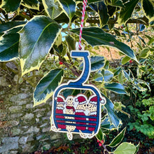 Load image into Gallery viewer, Decorative ornament shaped like a ski lift with soft coated wheaten terriers dressed up as Santas ready to go skiing.leaves.