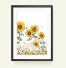 Load image into Gallery viewer, A framed art print featuring a whimsical illustration of yellow sunflowers, a soft coated wheaten terrier, and small bees on a white background, enclosed in a black frame and displayed against a light beige wall.