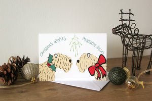 soft coated wheaten Terrier Christmas card with two wheatens under mistletoe  with holly and ribbon