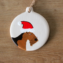 Load image into Gallery viewer, Airedale wearing a santa hat Christmas decoration
