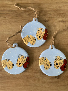 Example of three soft coated wheaten terrier Christmas decorations in the snow together