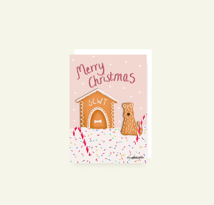 A fun cheerful Soft Coated Wheaten Terrier Gingerbread themed christmas card drawn by Harriet Billingham