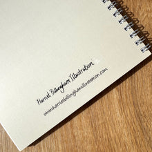 Load image into Gallery viewer, Spiral-bound notebook with text on a wooden surface
