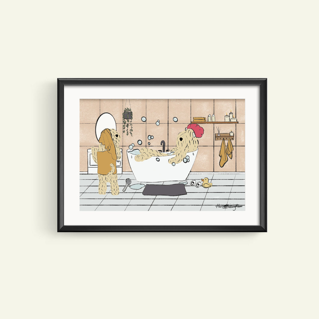 A framed print featuring an illustration of two toy dogs, one wearing a hat, enjoying a bath together. The background is a neutral color with a tiled wall and floor, and a towel hanging on a rack.