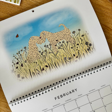 Load image into Gallery viewer, Soft coated wheaten terrier 2027 calendar drawn and designed by harriet billingham illustration in the UK. This shows the month of February of two wheatens touching noses in the spring grass.
