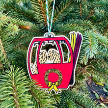Load image into Gallery viewer, Decorative Christmas ornament shaped like a ski lift with a wreath on a green tree.
