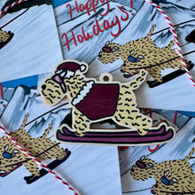 Load image into Gallery viewer, Soft Coated wheaten Terrier Christmas decoration. Made out of wood. In the shape of the dog wearing skis.
