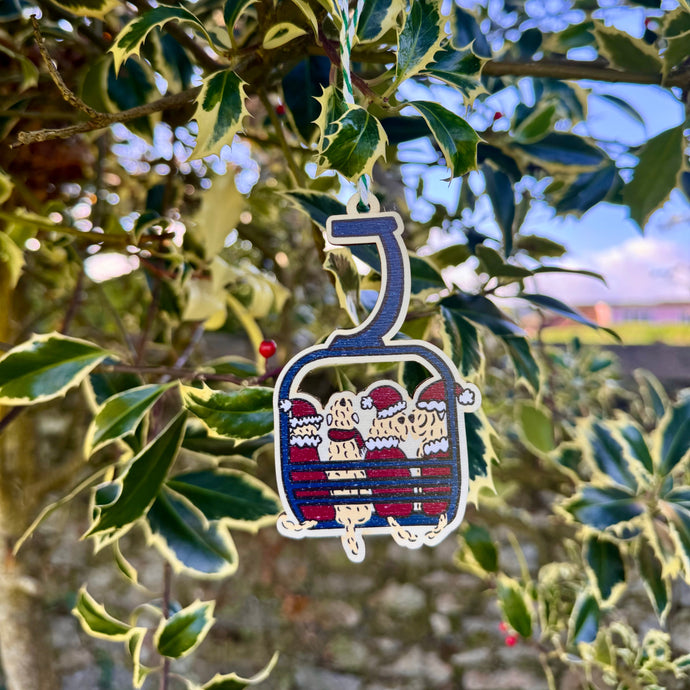 Decorative ski lift ornament hanging from a tree