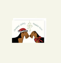 Load image into Gallery viewer, Airedale Christmas card drawn by Harriet Billingham illustrations. Two Airedales under mistletoe with Santa hat and ribbon
